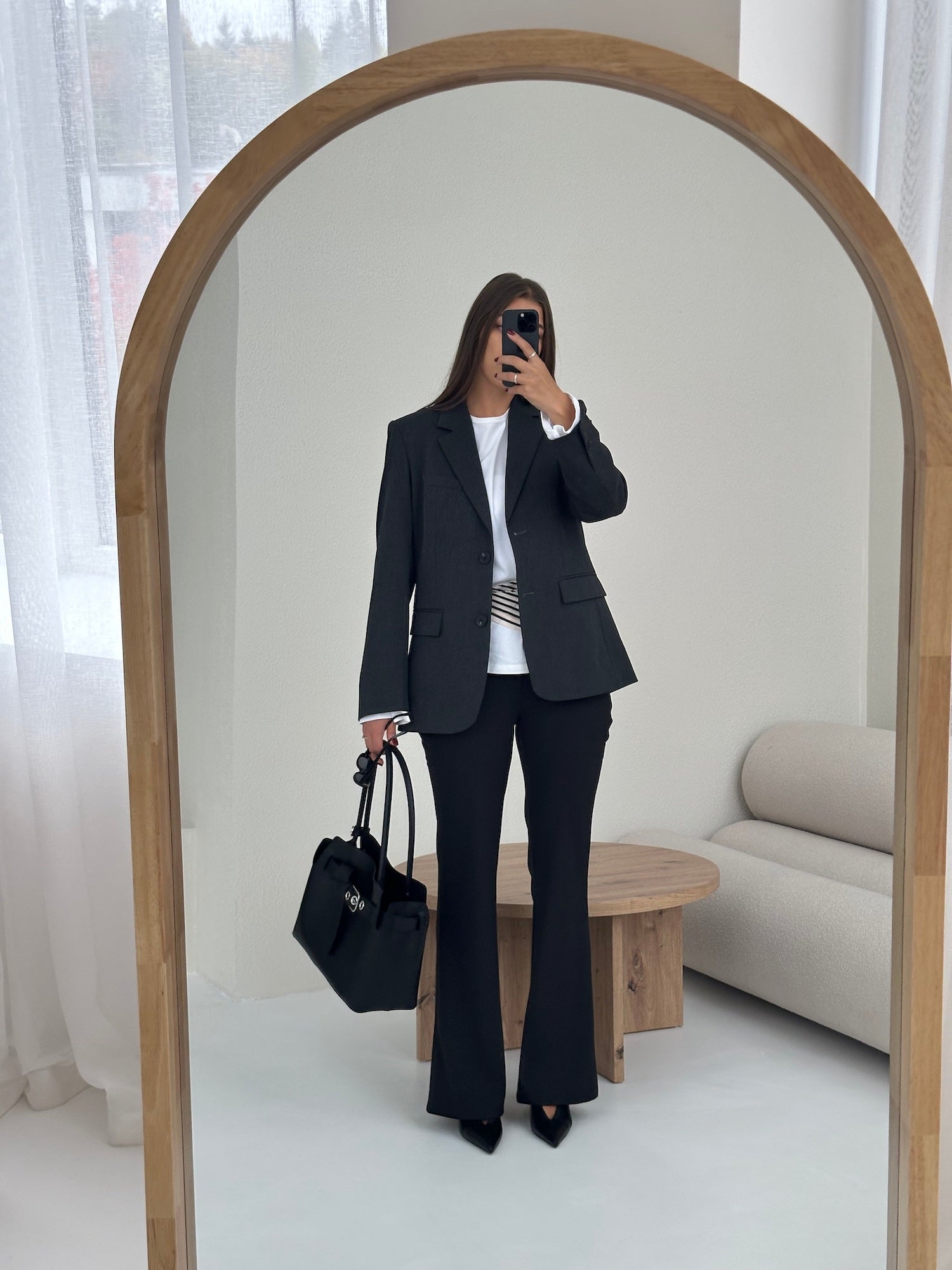 Woman wearing Ninepine black Perfect Blazer with tailored ponte bootcut pants, styled as a modern and polished work outfit.
