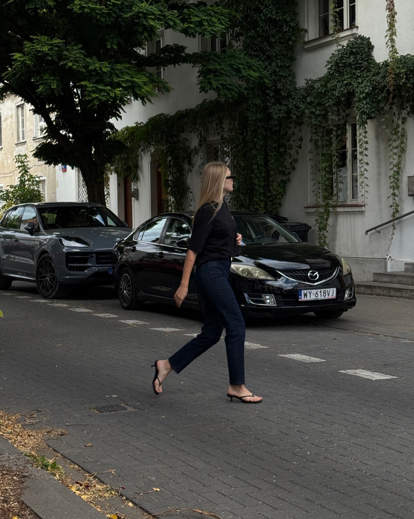Woman wearing Ninepine Slim ComfortDenim™ jeans in Dark Blue styled with a minimal outfit for an effortless city look.